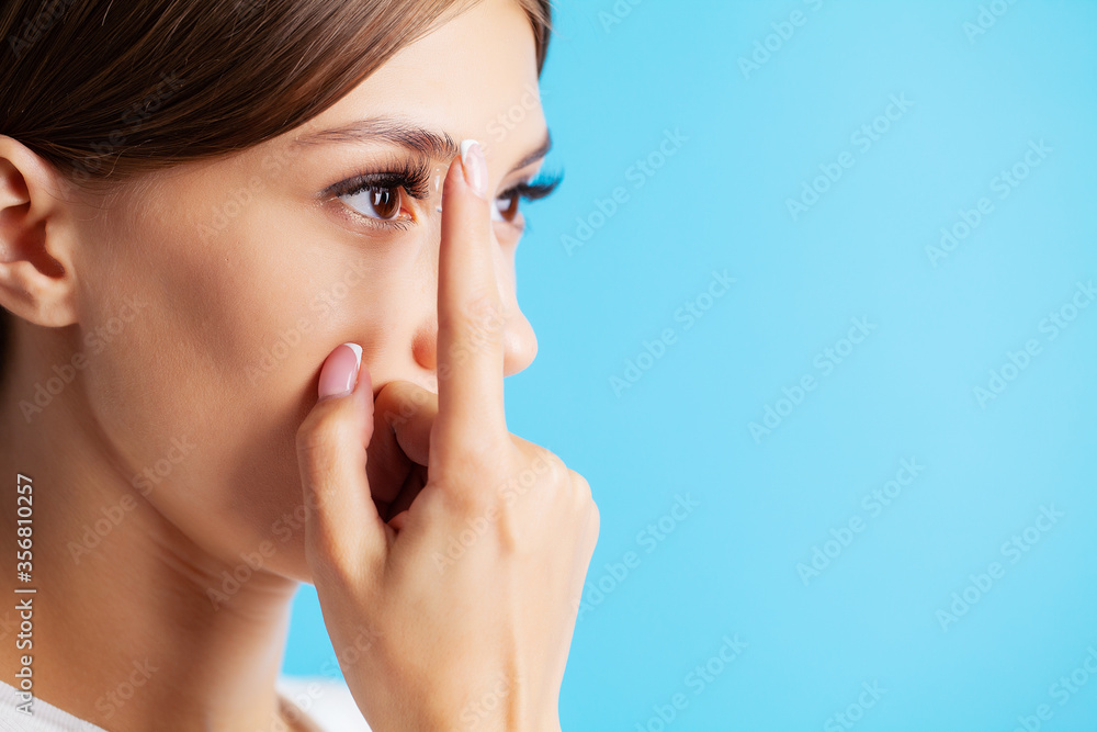 Contact lenses for vision. Close up of woman applying contact lenses Contact lenses for vision. Close up of woman applying contact lenses