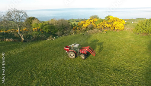 Tractor sowing Artificial Manure fertilizer on farm  photo