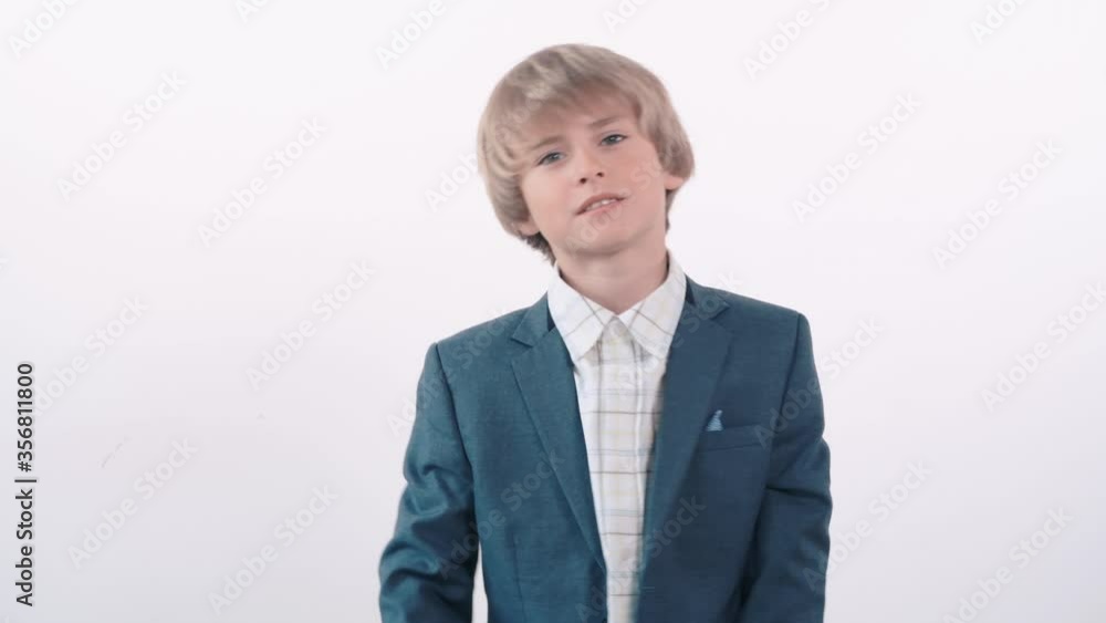 The cute blond boy is not happy, gesticulates and swears. The cute blond boy is not happy, gesticulates and swears.