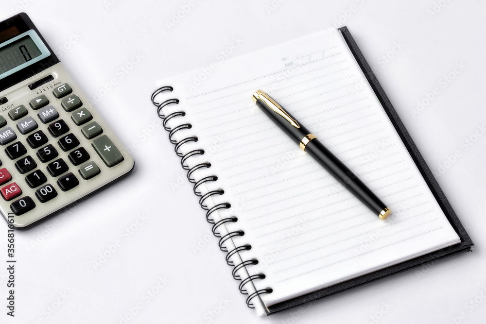 Work space on white desk with equipment office of note book, pen, calculator, Top view and copy space Work space on white desk with equipment office of note book, pen, calculator, Top view and copy space