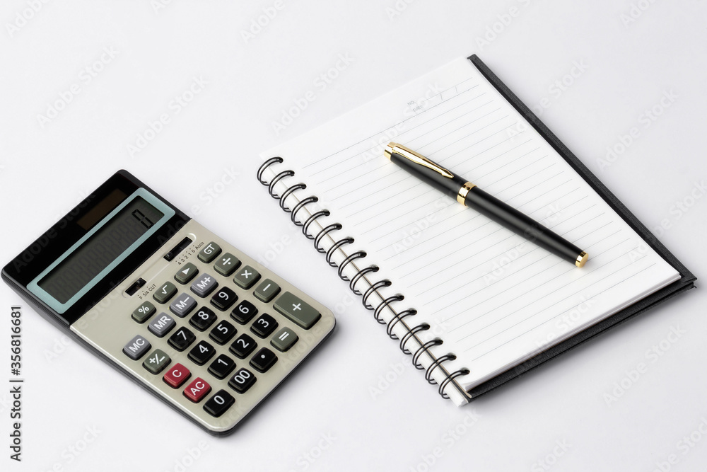 Work space on white desk with equipment office of note book, pen, calculator, Top view and copy space Work space on white desk with equipment office of note book, pen, calculator, Top view and copy space