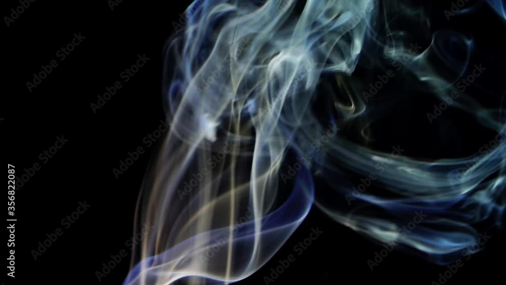 Real trickle smoke rising on black background with color changing Real trickle smoke rising on black background with color changing
