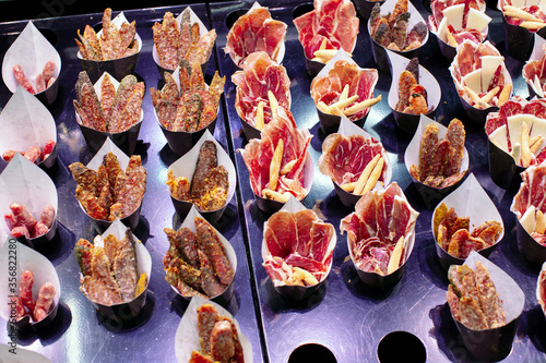 Photography Small taster packs of Jamón cured ham as well as sausage, bread sticks and chees