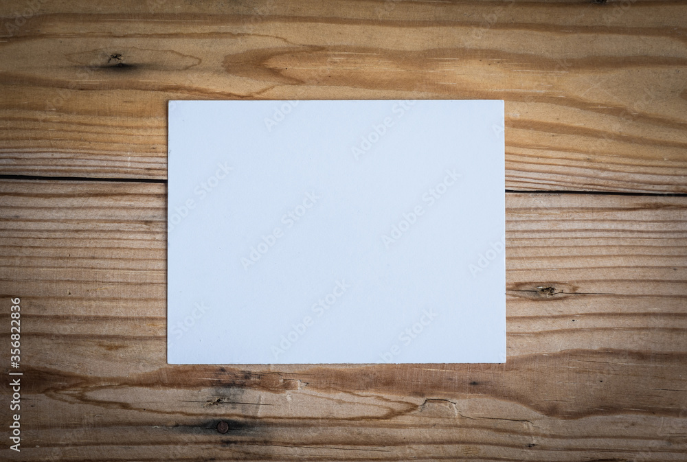 White note paper on wooden desk for background. White note paper on wooden desk for background.