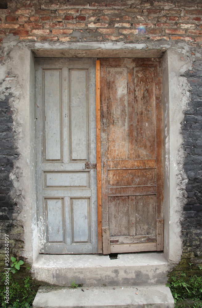 Brown door in facade of residential building surrounded by bricks