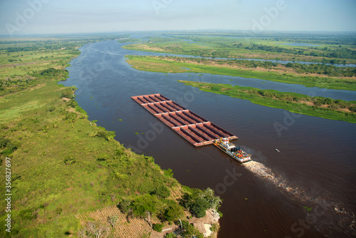 Valokuvatapetti Barge carrying iron ore on the Paraguay River in the region of Corumba, Mato Grosso do Sul,Brazil