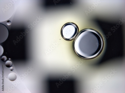 Beautiful white and black bubbles oil with shiny and gray color ,droplets macro image ,abstract background ,wallpaper