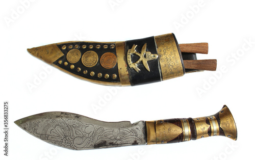 Antique Knife From Nepal on White Background Writing on Coins is government issue coin and monetary denomination 