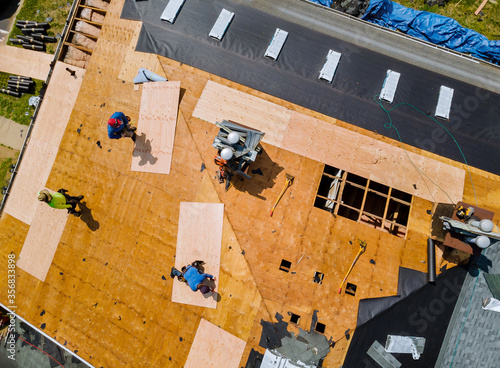 фотографія Removal old roof replacement with new shingles of an apartment building