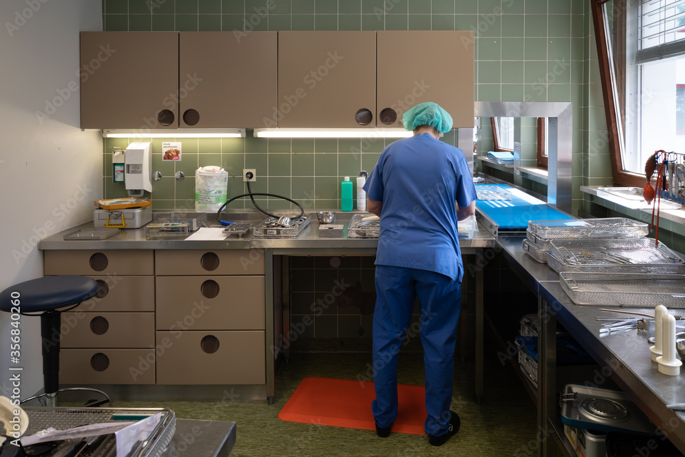  hospital employee prepares instruments in the sterilization department