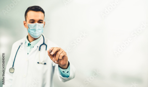 Doctor wear face mask in hospital protect from coronavirus disease or COVID-19. Medical staff are high risk people to receive infection from coronavirus disease or COVID-19. photo