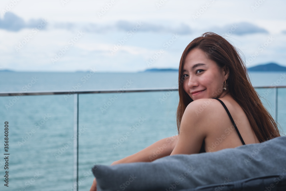 A beautiful young asian woman with the sea and blue sky view