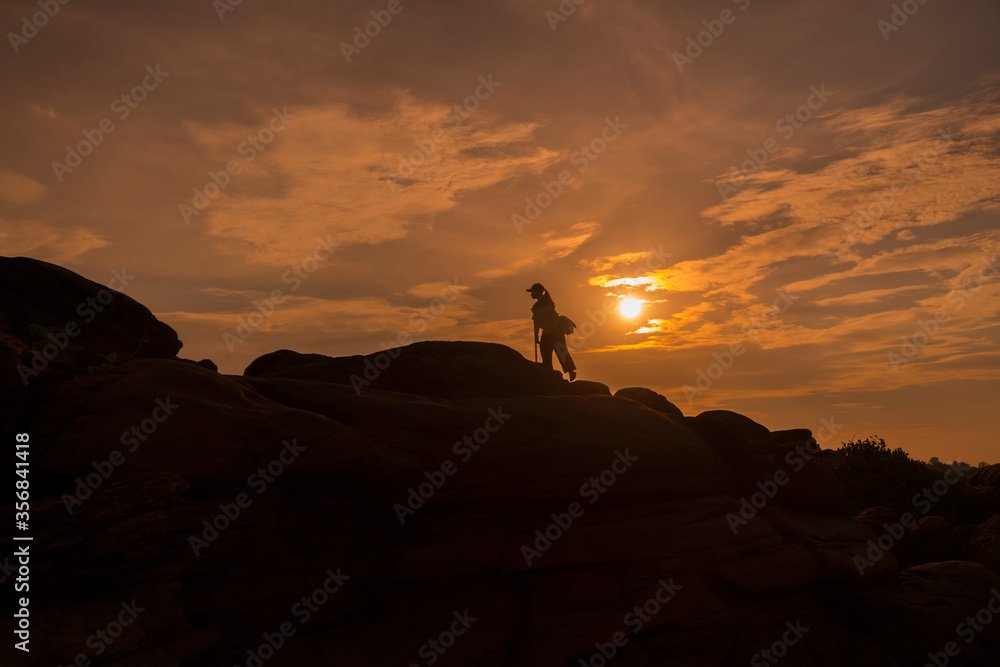 The silhouette of a woman walking up the hill The silhouette of a woman walking up the hill