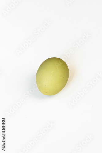 Multicolored village chicken eggs on a white background