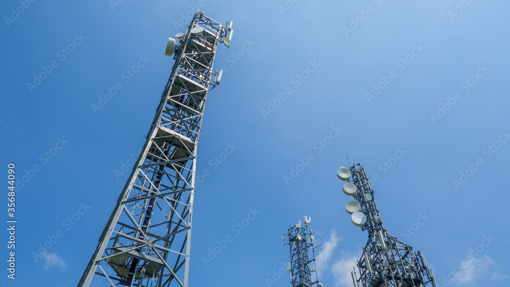 Group of towers for telecommunications, television broadcast, cellphone on mountain peak. Telecommunication center. Electromagnetic and environmental pollution Group of towers for telecommunications, television broadcast, cellphone on mountain peak. Telecommunication center. Electromagnetic and environmental pollution