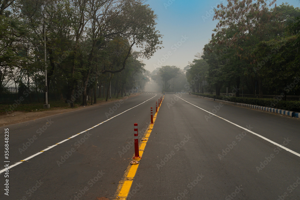 A deserted city road of kolkata city under lockdown due to corona virus. Kolkata is the capital city of West Bengal, India which came under lockdown to avoid getting people affected by corona virus.