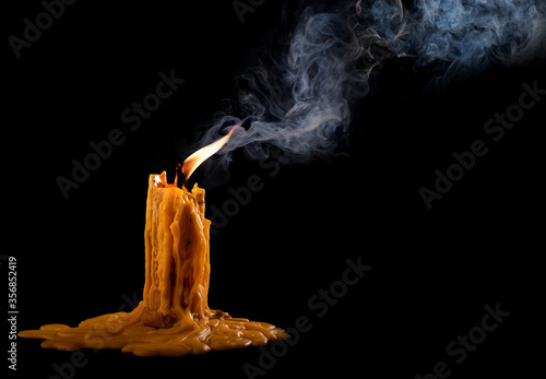 Fototapeta Naklejka Na Ścianę i Meble -  light flame candle burning brightly on black background
