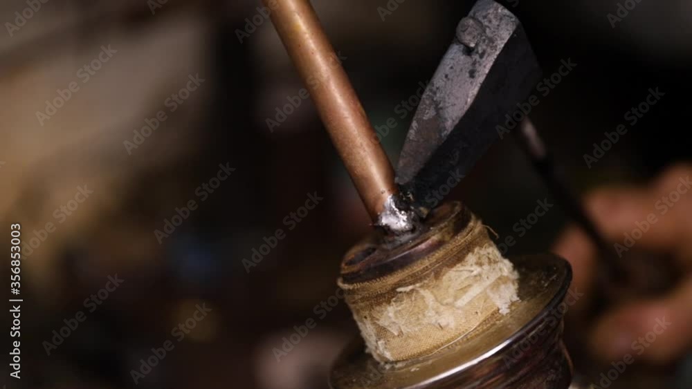 Hot liquid molten metal is welded on material to repair shisha stick, close up Hot liquid molten metal is welded on material to repair shisha stick, close up