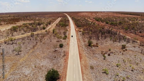 Car on the road in the red desert - Australia photo