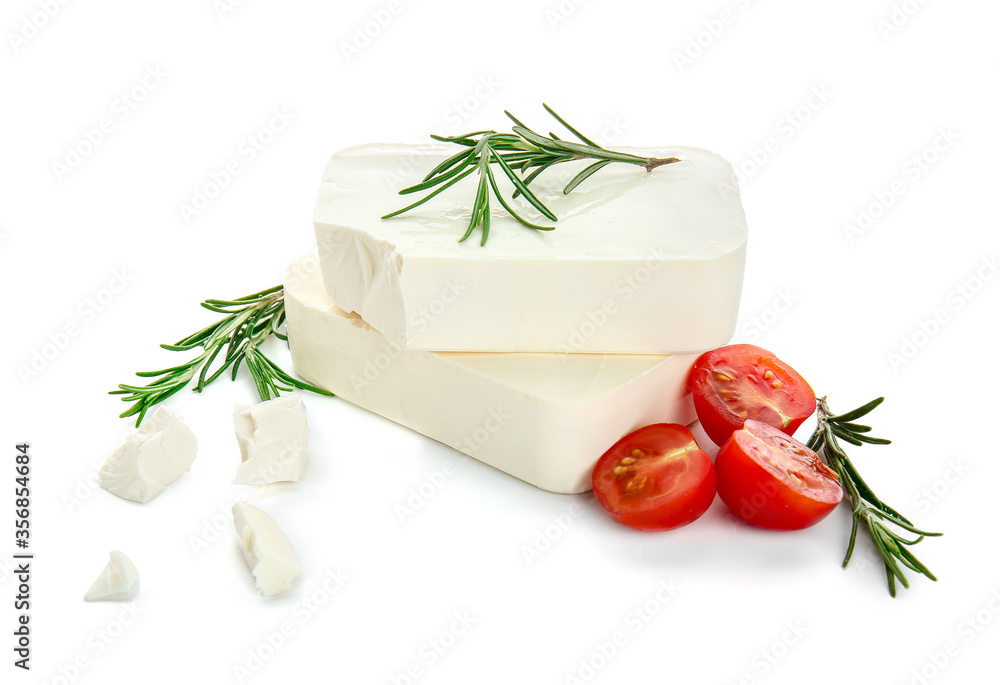 Tasty feta cheese with herbs and tomato on white background Tasty feta cheese with herbs and tomato on white background