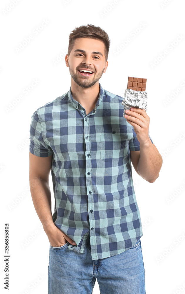 Handsome young man with tasty chocolate on white background Handsome young man with tasty chocolate on white background