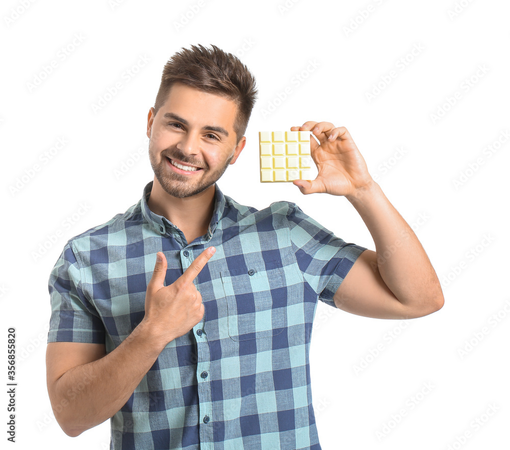 Handsome young man with tasty chocolate on white background Handsome young man with tasty chocolate on white background