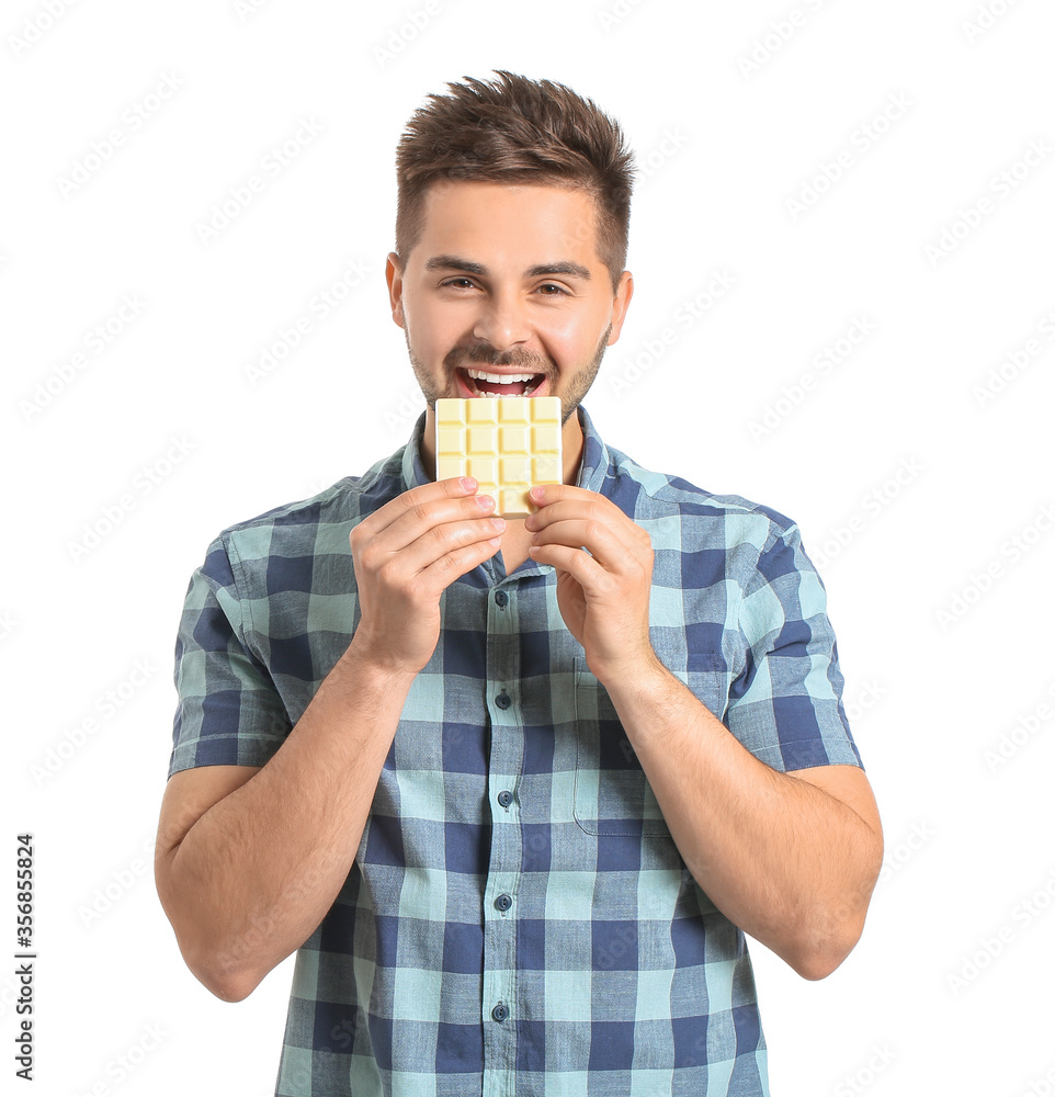 Handsome young man with tasty chocolate on white background Handsome young man with tasty chocolate on white background