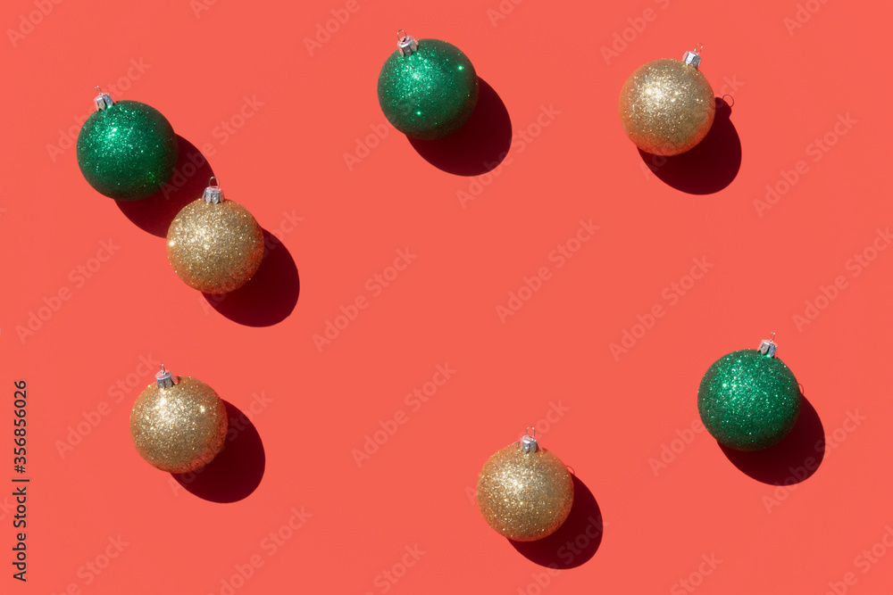 Fototapeta premium gold and green christmas ornaments pattern on a coral red background