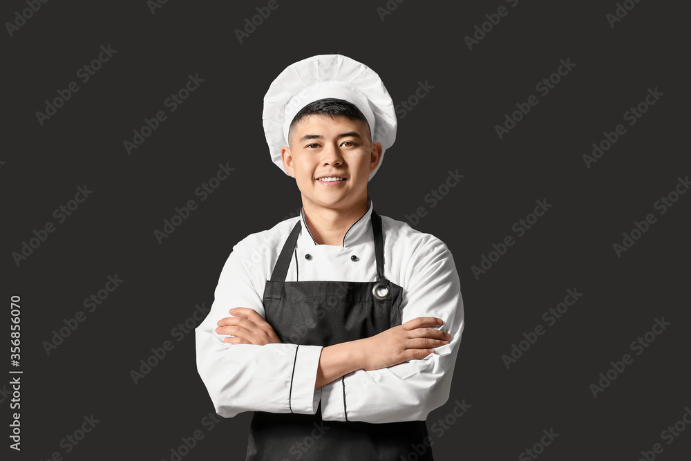 Handsome Asian chef on dark background Handsome Asian chef on dark background