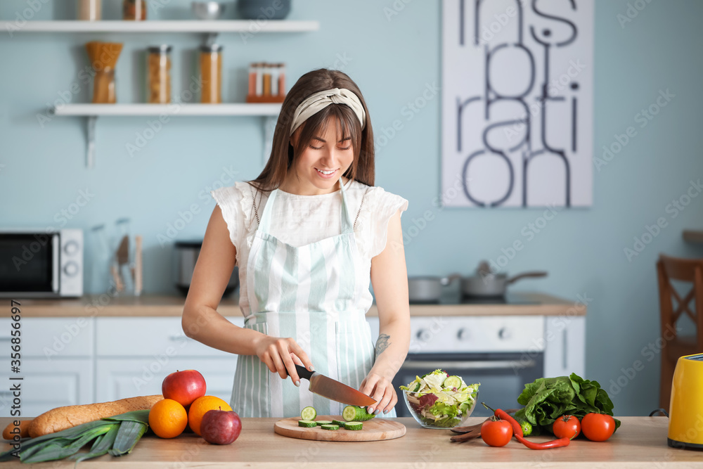 Beautiful young woman cooking in kitchen Beautiful young woman cooking in kitchen
