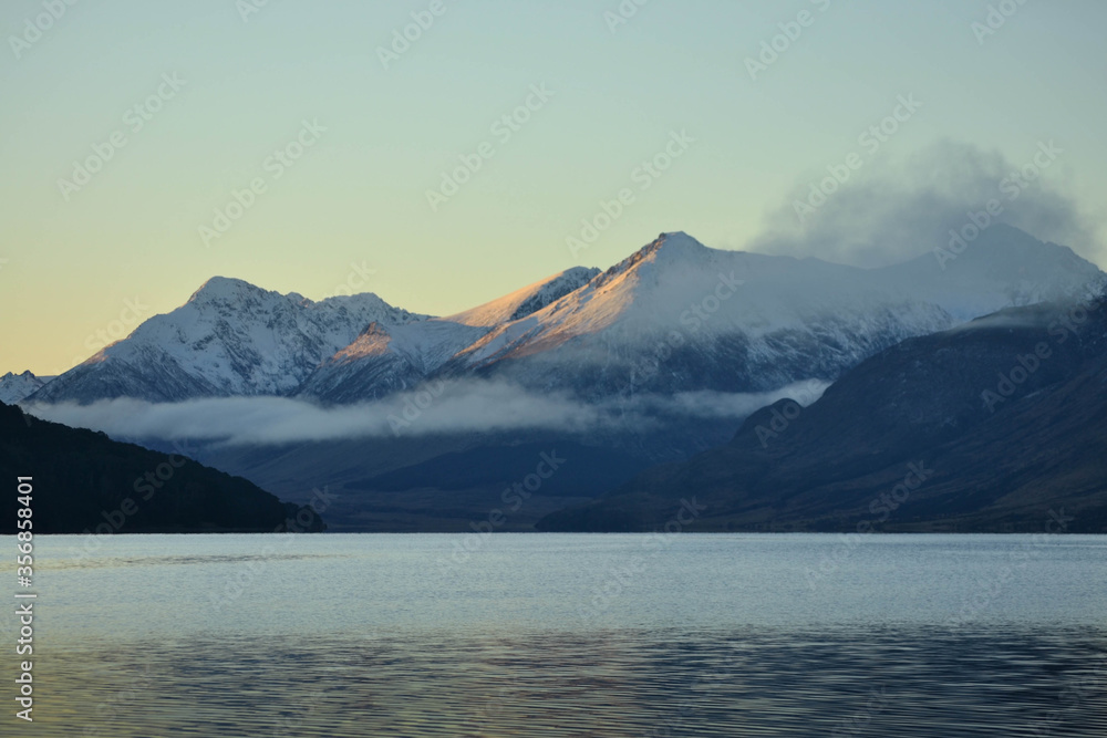 Snowcapped mountains and sunset by the lake.
