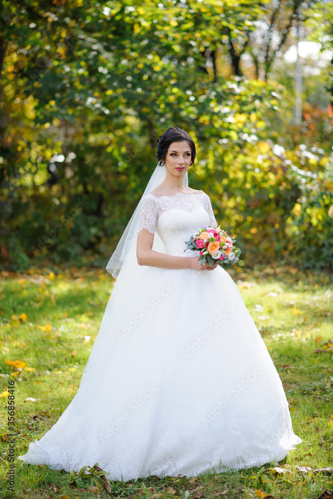 Portrait of a lonely bride on a background of an autumn park. Portrait of a lonely bride on a background of an autumn park.