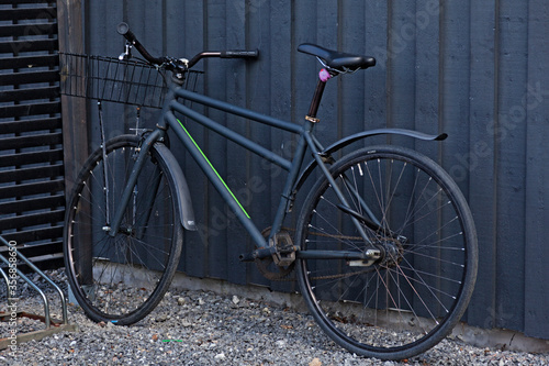 Umea, Norrland Sweden - May 10, 2020: black bicycle against dark outdoor wall at Haga