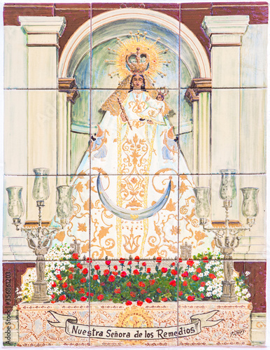 Madonna of los Remedios over glazed tiles wall. Patron saint of Hornachos, Extremadura, Spain photo
