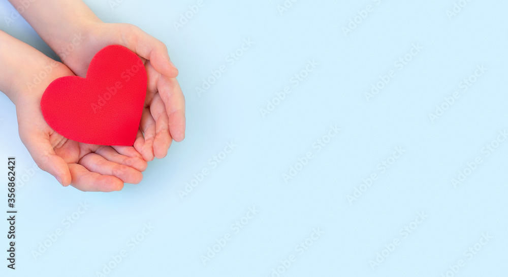 Children's hands hold red heart on a light background. ?oncept health care, organ donation, wellbeing, family insurance,love. World health day.National Organ Donor Day.World heart day.Banner - obrazy, fototapety, plakaty 