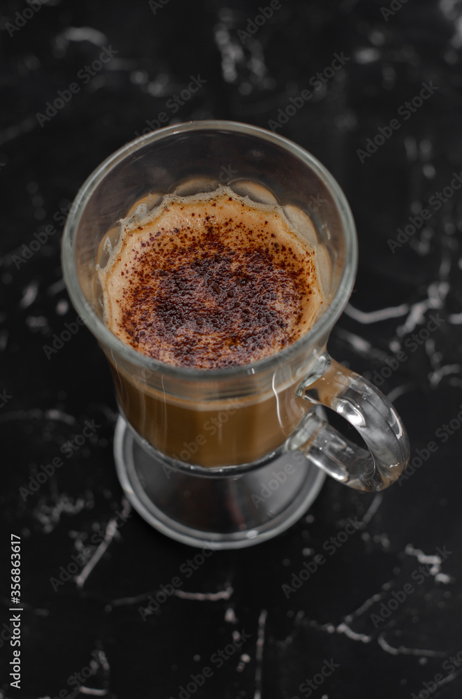 cup of latte on black background with notepad cup of latte on black background with notepad