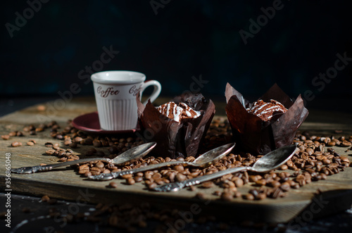 chocolate muffins on the table with a cup of coffee