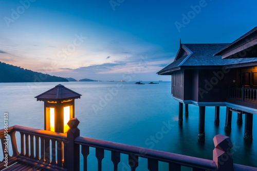 Peaceful and quiet view of the ocean with wooden houses on stilts at the Straits of Malacca  photo
