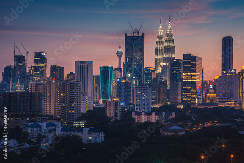 Photography Evening view of the Kuala Lumpur Twin Towers and KL Tower city skyline, Malaysia