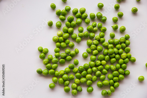 Green fresh peas ans pea pods isolated on white top view.