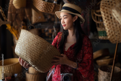Fotografie Asian girl, travel and shopping in traditional basketry shop