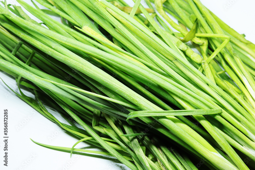 Fresh Green Spring Onion With Roots On An Isolated White Background Fresh Green Spring Onion With Roots On An Isolated White Background