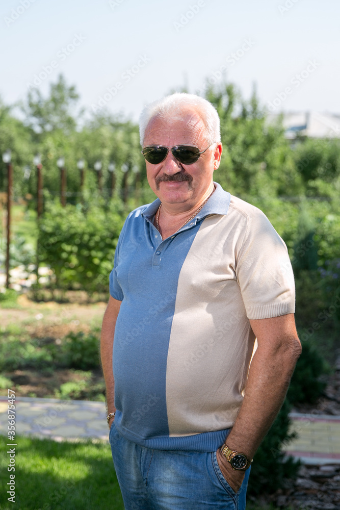 Senior grey-haired man in sunglasses in summer Senior grey-haired man in sunglasses in summer