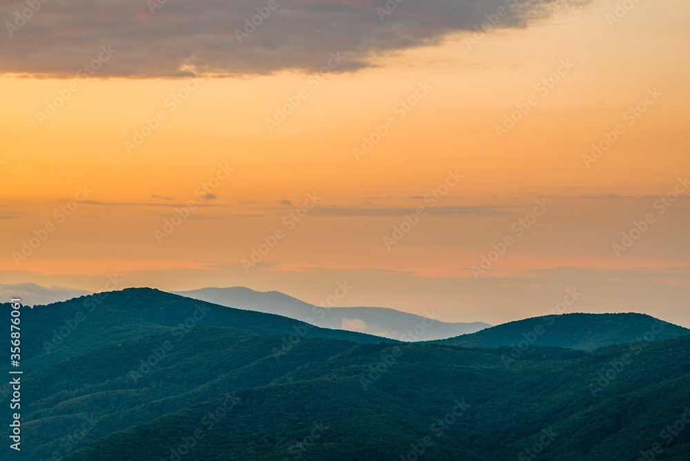 landscape in the mountains at sunrise. beautiful landscape of the Carpathians. wonderful weather in summer.orange sky burning shadows.