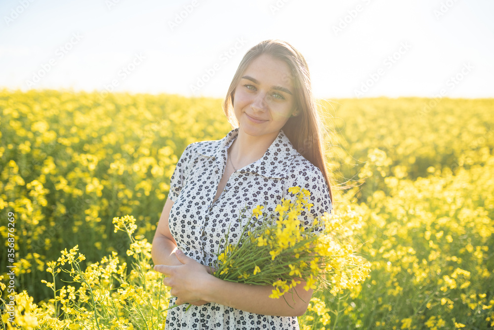 Beautiful girl in a rapeseed field, with her hair in the sun. Beautiful girl in a rapeseed field, with her hair in the sun.