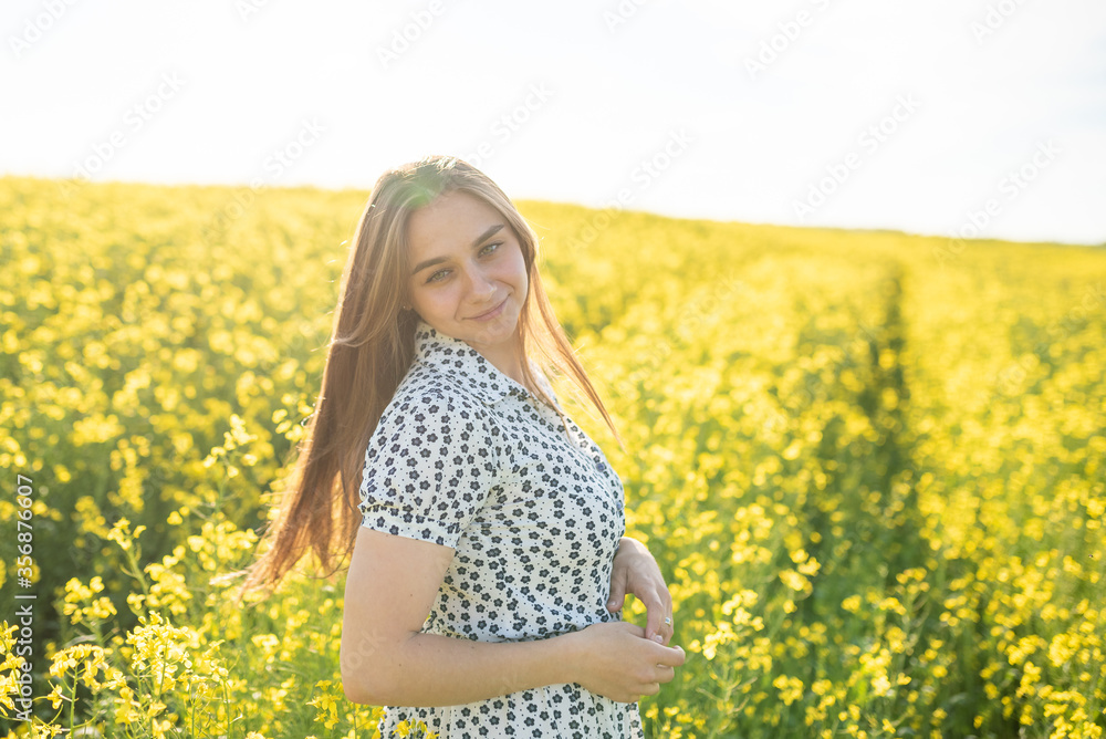 Beautiful girl in a rapeseed field, with her hair in the sun. Beautiful girl in a rapeseed field, with her hair in the sun.