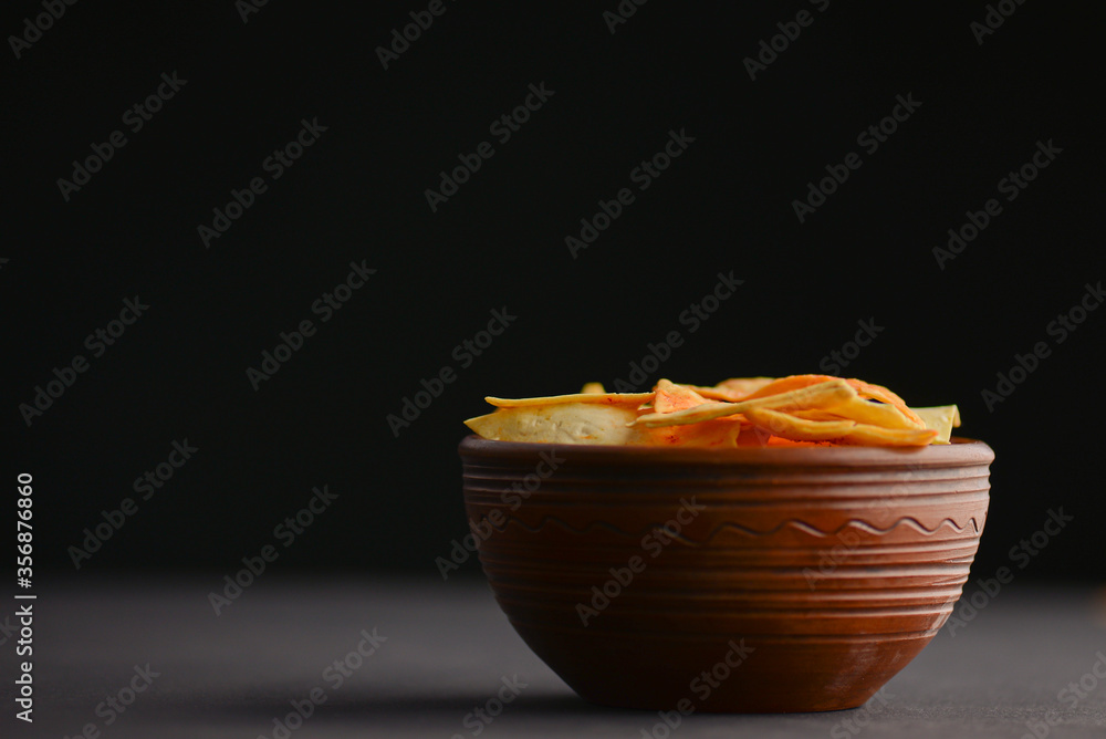 Nacho cheese tortilla chips in a bowl. Crisp golden unhealthy chips, junk food, fast food