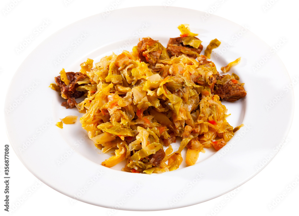 Delicious meat dish – pork with stewed cabbage served on plate
