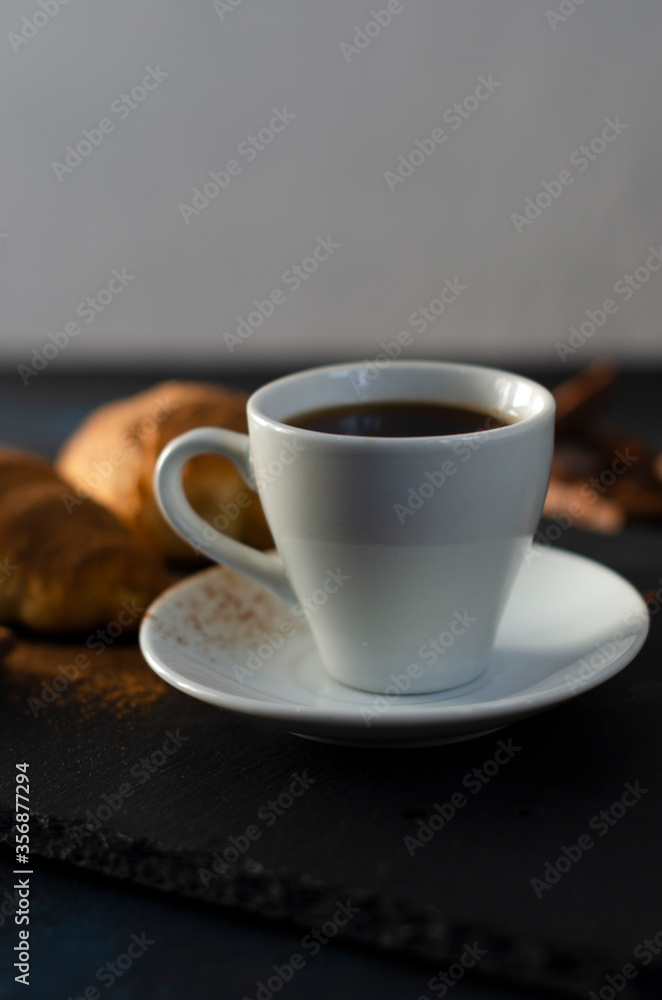 cup of coffee with chocolate croissants on the table