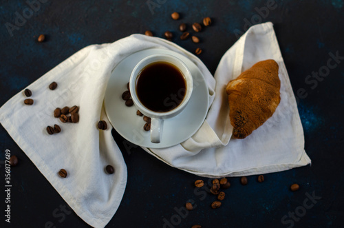 cup of coffee with chocolate croissants on the table